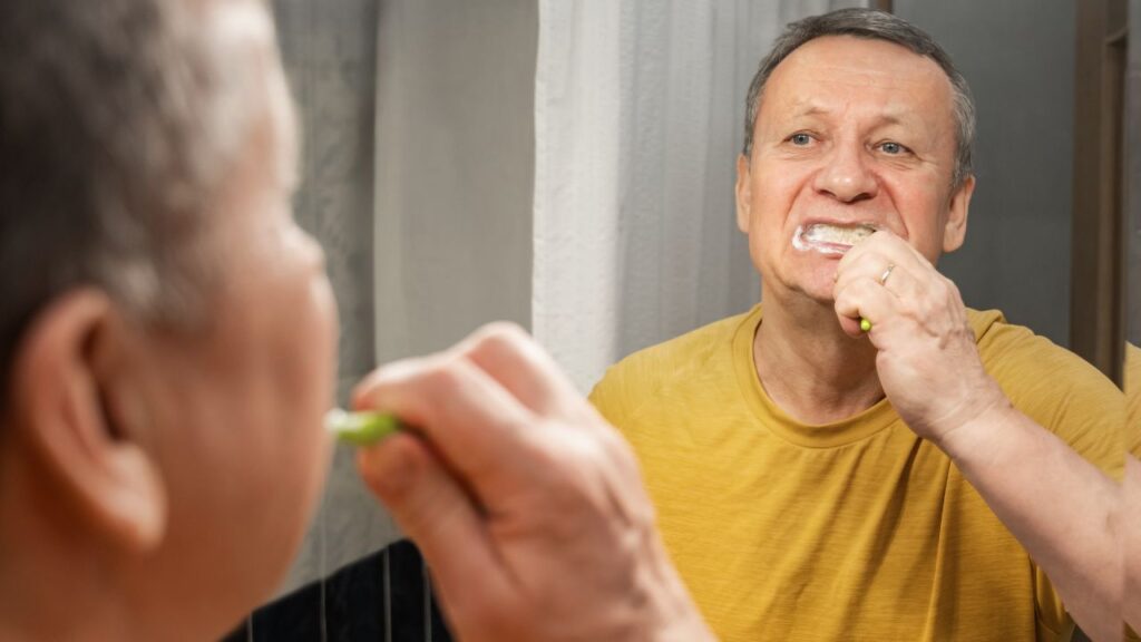 Adult brushing teeth as part of a daily oral hygiene routine
